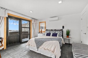 First bedroom features a queen bed, large window with a lake view, and a closet for convenient storage.