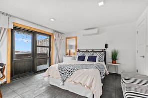 First bedroom features a queen bed, large window with a lake view, and a closet for convenient storage.