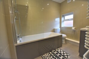 bathroom with shower over