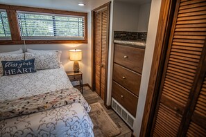 The room has a queen size bed and storage