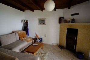 The sitting room features a wood stove with an oven and a sleeper/sofa.