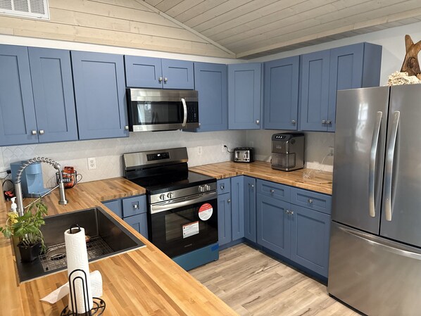 Brand new kitchen with fridge, oven, dishwasher and microwave