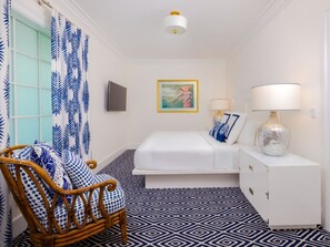 Charming room with bold blue patterns and natural light, creating a cozy and cheerful retreat.