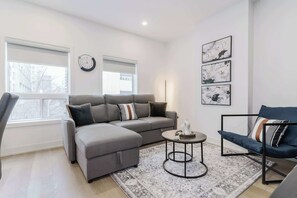 Living room with sofa bed and lots of natural light