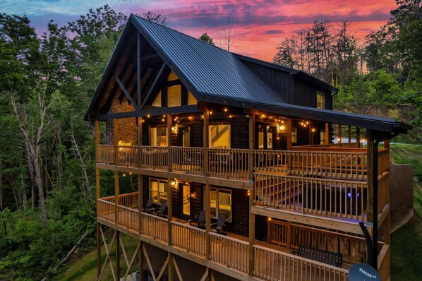 Main deck has hot tub, fireplace, and cozy seating