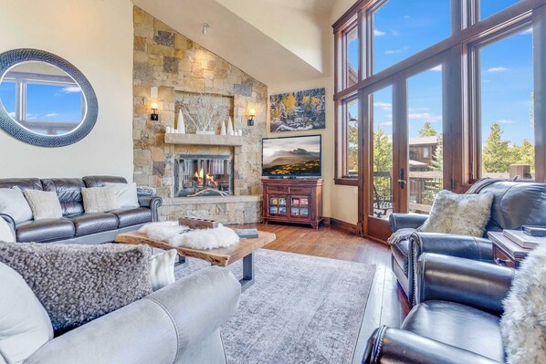 Great Room on main floor with gas fireplace, flatscreen tv, and access to the large decks. - Summer Season