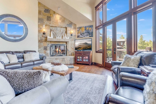Great Room on main floor with gas fireplace, flatscreen tv, and access to the large decks. - Summer Season