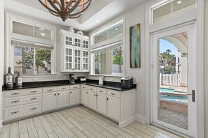GOURMET, FULLY-STOCKED KITCHEN: Cook in style with upscale appliances, custom cabinetry, and Pool and Hot Tub Views!