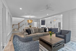 Open concept with comfortable seating and dining open to chef's kitchen