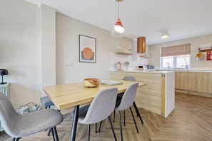 Comfy social dining space, next to kitchen. Doubles as a work and meeting space