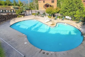 Take a dip in the sparkling outdoor pool just steps from the cabin! Whether you're soaking up the sun or enjoying a refreshing swim, this community pool is the perfect spot to unwind after a day of mountain adventures.