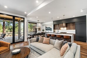 Relax in the inviting great room, where soaring ceilings and large windows flood the space with natural light while framing the picturesque mountain scenery. Cozy up by the fireplace and enjoy the Smart TV.