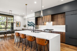 A chef's delight! The gourmet kitchen features sleek countertops, state-of-the-art appliances, and an island perfect for meal prep or casual dining.