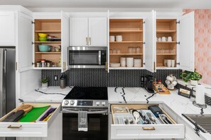 From coffee to cocktails, this sleek kitchen has it all- perfect for group meals