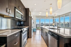 the expansive open floor plan blends the kitchen, dining room, and living room, offering a bright, welcoming atmosphere throughout.
