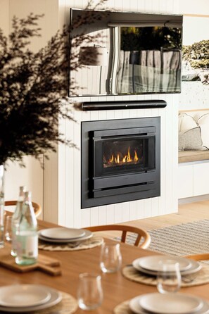 Modern Entertainment Hub I Transform your living space with our sleek flat screen TV, seamlessly integrated above a cozy, contemporary fireplace. Enjoy stunning visuals and immersive sound, perfect for movie nights or binge-watching your f