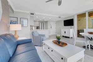 The open, main living area includes living, dining and kitchen - all share a view of the wall mounted TV with community provided DirecTV programming.