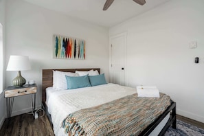 A cozy and stylish bedroom with a plush bed, soft linens, and a modern touch, perfect for a peaceful night's sleep.