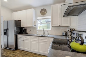 A bright and spacious kitchen with stainless steel appliances, ample storage, and everything you need for a comfortable stay.