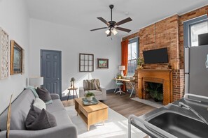 private living room with smart Tv and desk 