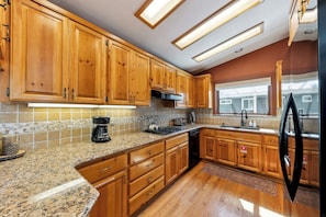 The kitchen is equipped with full sized appliances