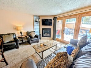 Relax by the gas fireplace on a snowy day in