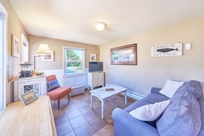 Relax in this sunny, welcoming living room—perfect for cozy evenings and laid-back mornings.
