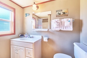 Bright and tidy bathroom with a single vanity, fresh towels, and all the essentials.