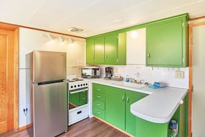 Fully equipped kitchen with fridge, oven, microwave, and toaster—everything you need.