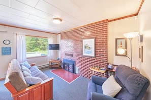 Bright and cozy living room with a queen-size futon—perfect for lounging or accommodating extra guests.