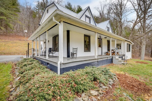Side view, picnic table on porch. There is no railing on the porch just stairs.