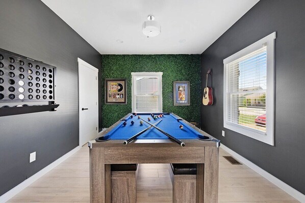 A sleek game room with bold design and boutique character.