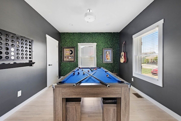 A sleek game room with bold design and boutique character.