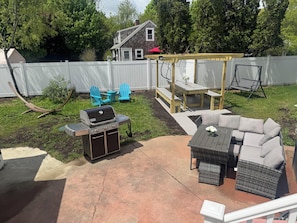 Backyard area with pergola and lots of lawn furniture