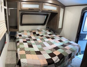Bed is an actual mattress, not a camping mattress. Bedroom has 2 closets for clothes storage.
