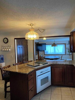 Dining area has TV, card table, coffee bar, and wine rack.