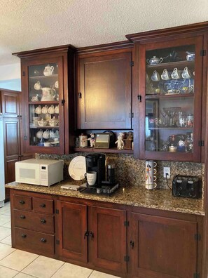 Kitchen comes equipped with fridge, oven, stove, dishwasher, microwave, toaster, blender, coffee maker.