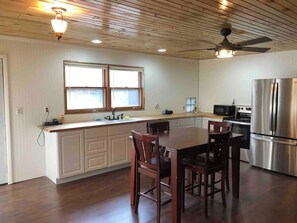 Fully equipped kitchen with dining table.