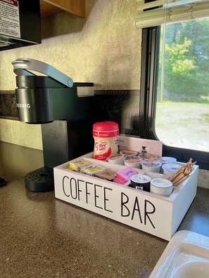 Keurig, gas stove, oven, sink, fridge and kitchen complete with the essentials.