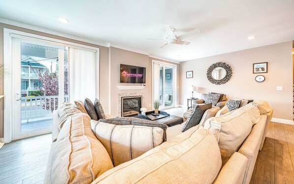 Comfy open living room area with plush seating and fireplace