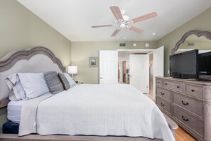 Smart TV and ceiling fan in this bright and cozy room