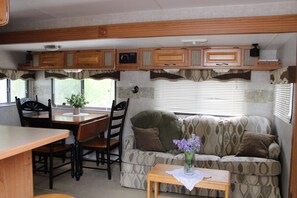 Living Room w/ pull out couch and kitchen table.