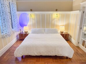 Relax and unwind in this spacious and serene bedroom designed for ultimate comfort.