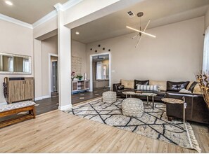The home has two living rooms/guest seating areas, with a Baby Grand Piano