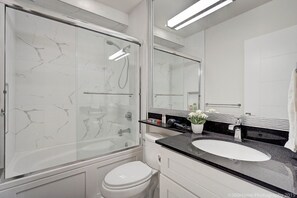 bathtub, shower, sink, and toilet
