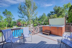 The private hot tub offers a perfect spot to relax, surrounded by peaceful views. Comfortable seating nearby makes it easy to unwind after a day of exploring.
