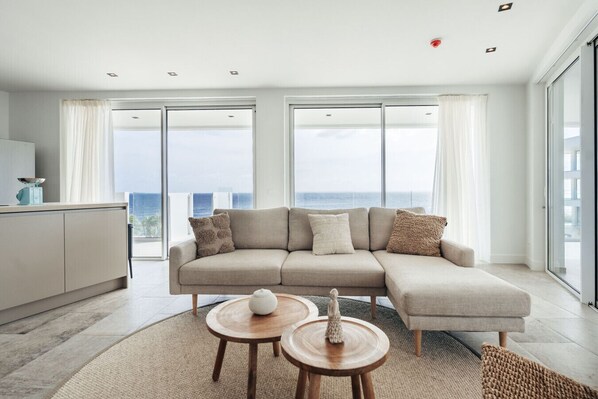 Relaxing in style! This modern living space offers a stunning view, perfect for unwinding with a good book or enjoying a cup of coffee.