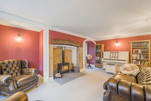 Beech House, Evershot: The snug comes complete with a piano and wood burning stove