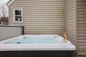 Unwind in the bubbling hot tub, the perfect way to relax after a day of adventure. Whether you're sipping on a glass of wine or stargazing in the crisp evening air, this inviting space offers ultimate comfort and tranquility.