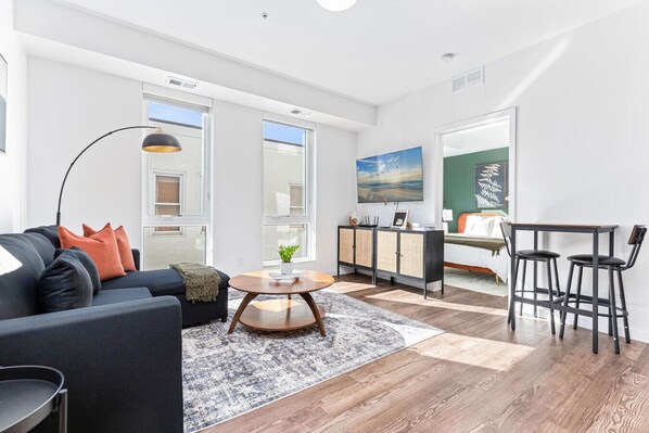Relax in this warm, inviting space with wooden accents and cozy furnishings. You’ll love unwinding on the plush sofa, enjoying a good book or streaming your favorite shows in a serene atmosphere